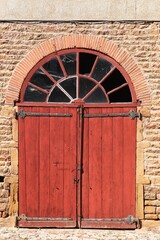 Old wooden door at the castle of Montmelas in Beaujolais, France