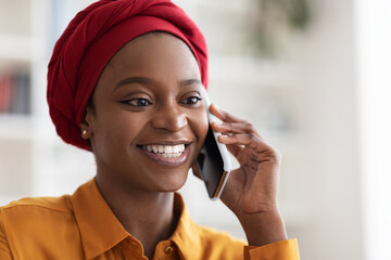 Closeup portrait of pretty muslim black woman talking on phone