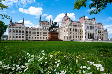 Hungarian parliament in Budapest with grass and flowers