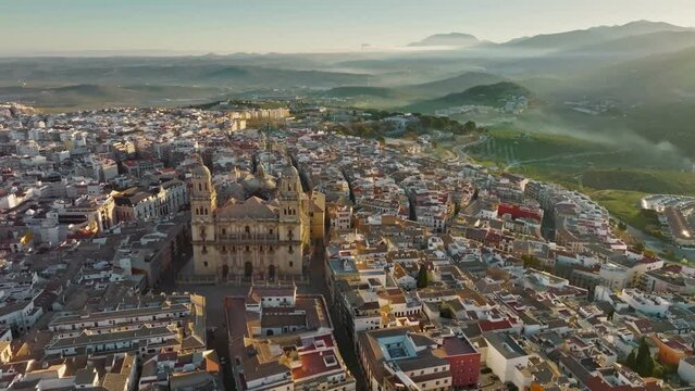 Aerial view of Jaen Cathedral early in the morning. Jaen, Andalucia, Spain with foggy green hills at background. UHD, 4K.