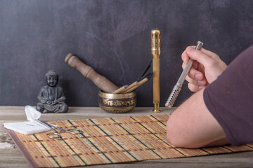 Obraz na płótnie Canvas TCM Traditional Chinese Medicine, hand applying moxa stick.