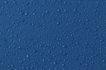 Water droplets on a colored texture. Decorative texture with water drops.