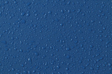 Water droplets on a colored texture. Decorative texture with water drops.