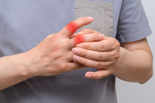 Hands of men suffering from finger joint pain. Causes of rheumatoid arthritis, gout. Health care and medical concept.