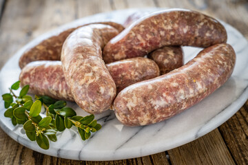 Raw white sausages on wooden table
