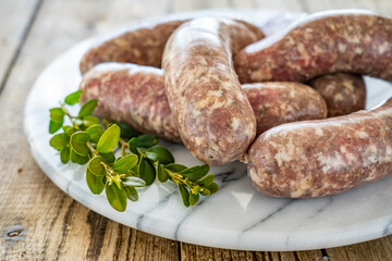 Raw white sausages on wooden table

