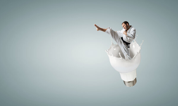 Portrait of a karate man jumping for kick