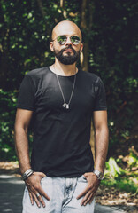 Portrait of a fashion young man at beautiful background in jungle