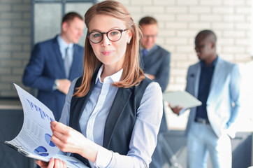 business woman with her staff, people group in background at modern bright office indoors