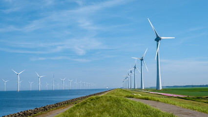 Offshore Windmill farm in the ocean Westermeerwind park, windmills isolated at sea on a beautiful bright day Netherlands Flevoland Noordoostpolder. Huge windmill turbines - obrazy, fototapety, plakaty