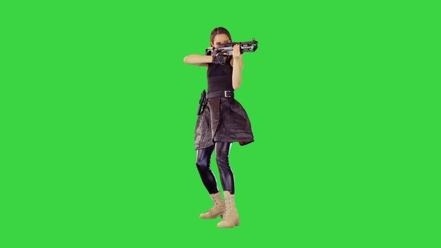 Girl with a gun searches for aim and makes a single shot on a Green Screen, Chroma Key.