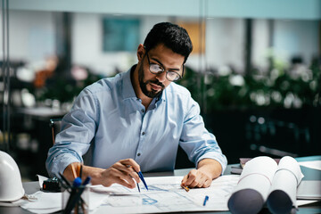 Concentrated busy handsome millennial islamic male engineer with beard in glasses, think about...