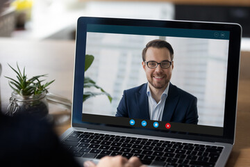 Laptop display with interface of video call to happy successful millennial businessman, business...