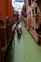 Gondoliers on the canals of Venice carry tourists..
