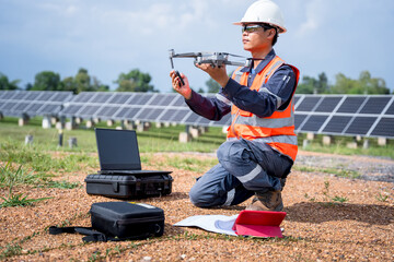 Engineers preparing drones to fly, inspecting the solar cells at high angles to thermo scan the...