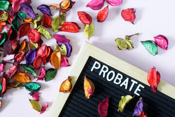 Probate lettering next to dry colorful leaves and petals. The concept of inheritance and memory of...