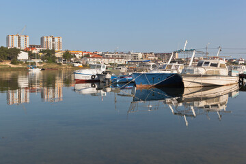 Fototapeta na wymiar Boats at the pier in the early morning in the Cossack Bay of the city of Sevastopol, Crimea