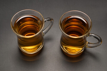 A turkish glass of tea on black background.