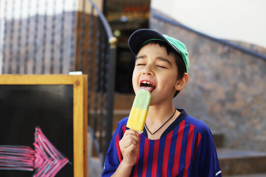 boy eats and licks ice cream
