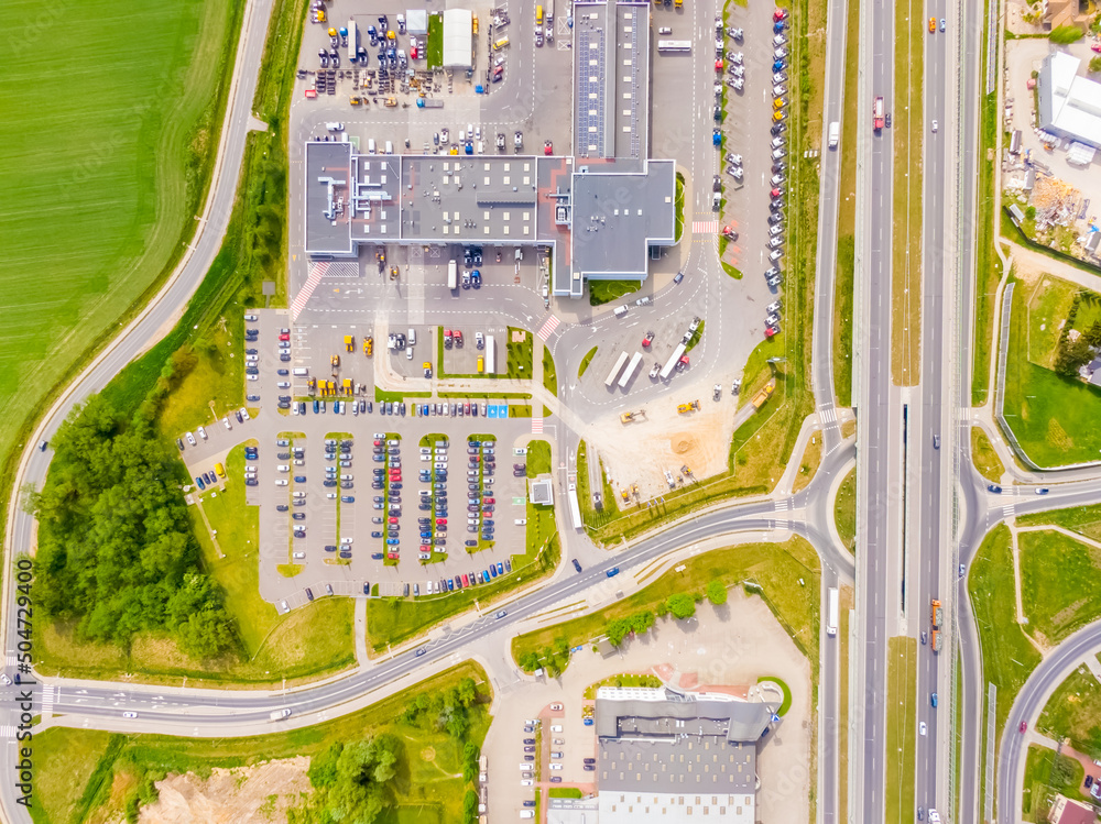 Poster aerial view of colorful trucks in the terminal waiting for unloading. top view of the logistics cent