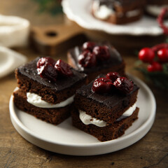 Chocolate cake with cherries and cream
