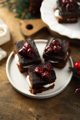 Chocolate cake with cherries and cream