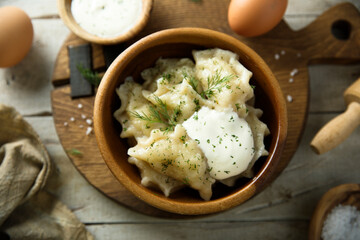 Homemade dumplings with potato, dill and sour cream