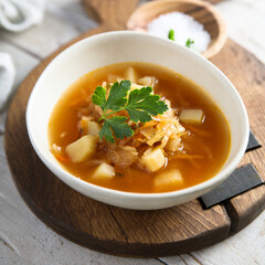 Traditional homemade sauerkraut soup with fresh parsley