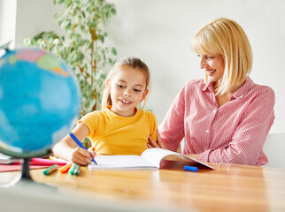 Fototapeta premium homework teaching education mother children daughter familiy childhood child teacher classroom school