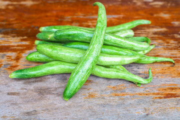 Close up of snake gourd on wood table.