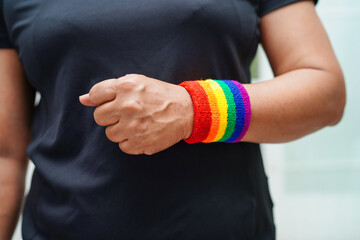 Fototapeta premium Asian woman with rainbow flag, LGBT symbol rights and gender equality, LGBT Pride Month in June, LGBTQ, LGBTI, LGBTQA, LGBTQIA