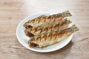   deep fried salty mullet fish arranging on plate