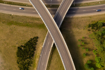 Drone view of highway and 2 bridges shaped like x.
