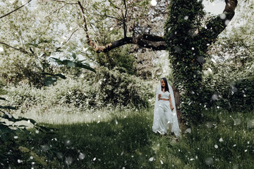 woman with a white dress in a forest with flowers