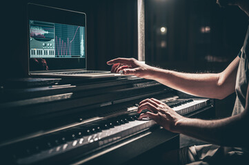 A man composer, producer, arranger, songwriter, musician hands arranging music. - obrazy, fototapety, plakaty