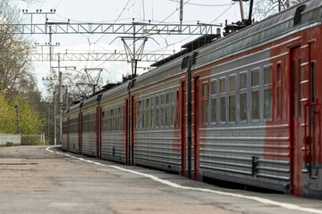 Suburban electric train cars on the platform of the station
