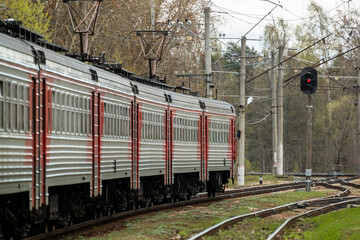 Naklejka premium A suburban electric train is waiting for a semaphore permission signal to start moving