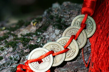 A bunch of Chinese Feng Shui coins in close-up. The background image. Wooden background. Chinese...