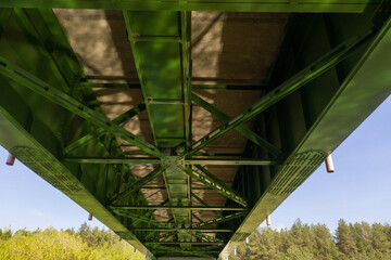 Drone view of bottom of the bridge with sun reflection