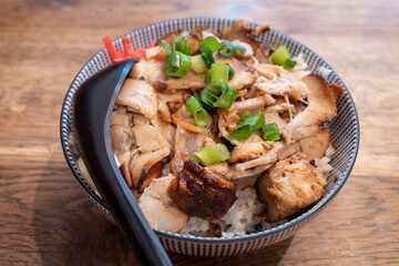 Selective focus at Japanese Roast with rice bowl, on wooden table.