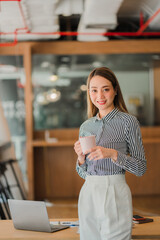 Portrait of a smiling Asian businesswoman standing. at the desk, business concept, financial accounting