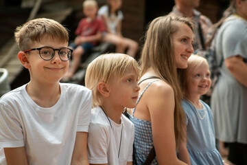 Portrait of large family in summer on the street young mother and three children. Portrait of siblings. Childrens camp. Outdoors.