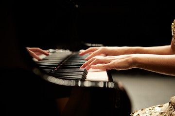 hands of a person playing piano