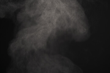 Closeup of water steam over black background