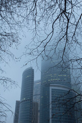 Foggy view of the towers of the Moscow International Business Center Moscow-City. Modern glass skyscrapers. Foggy cityscape. Moscow, Russia.