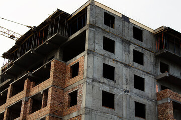 Building under construction. Post-soviet architecture.  Facade of multistory apartment house. 