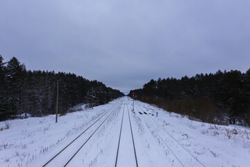 Drone photography of winter forest and railway during cloudy day