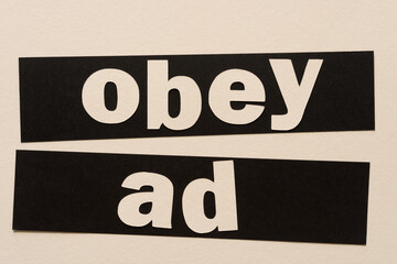 words on paper: "obey ad"