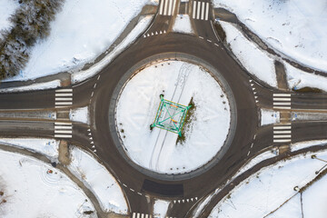Drone view of roundabout on sunny winter evening day.
