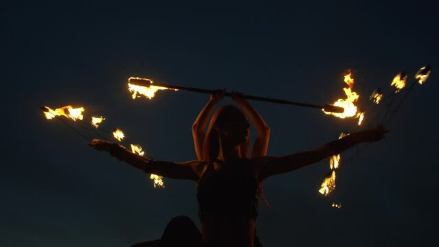Dynamic fire show. Sexy couple perform poi dance blue sky. Poi performance. Fire dancing. celebration. Performing art. Fun and entertainment
